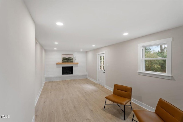 unfurnished room with a fireplace and light hardwood / wood-style flooring