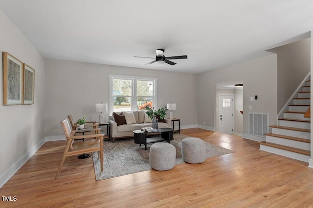 living room with ceiling fan and light wood-type flooring