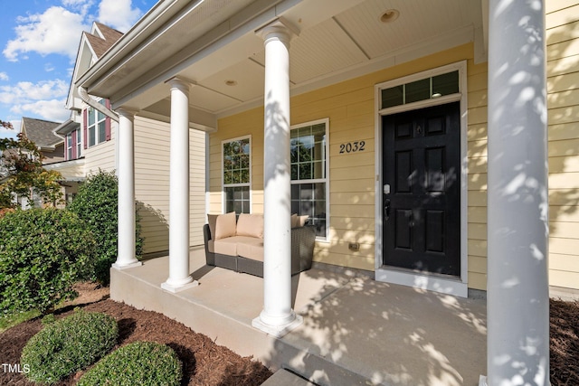 view of exterior entry with a porch