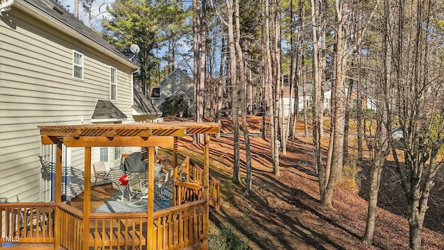 wooden deck featuring a pergola