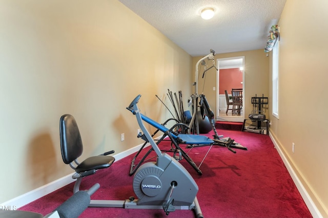 workout room featuring a textured ceiling