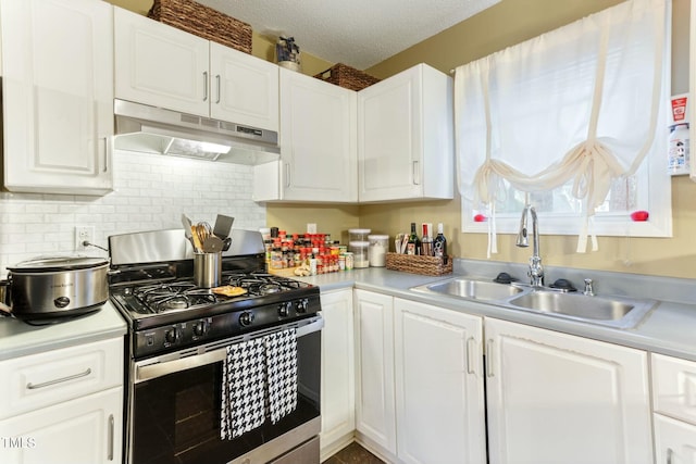 kitchen with sink, white cabinets, a textured ceiling, and stainless steel gas range