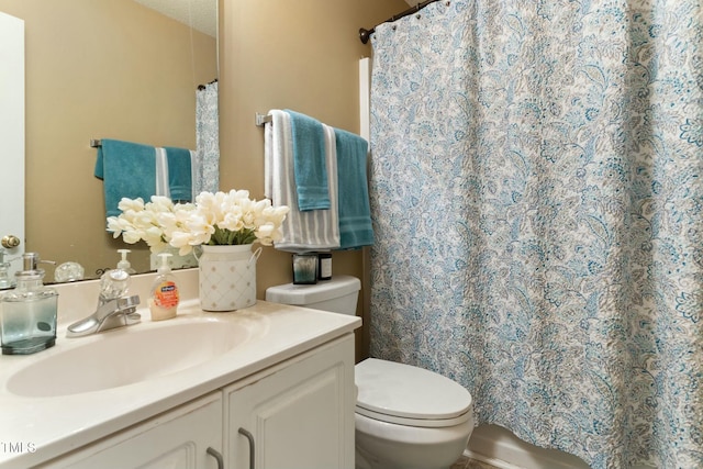 bathroom with vanity, toilet, a textured ceiling, and walk in shower