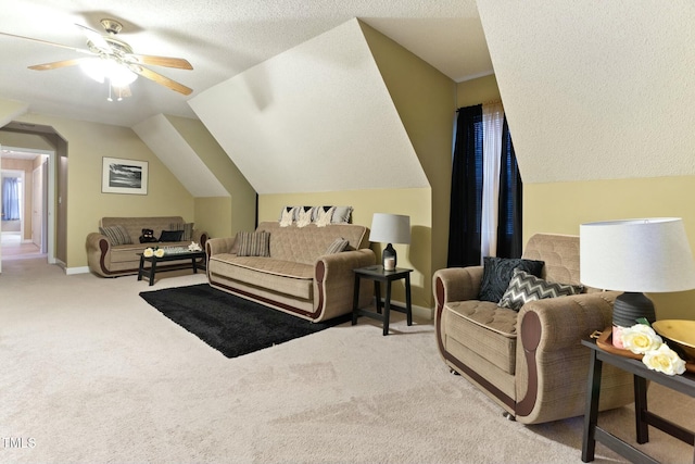 carpeted bedroom with a textured ceiling, ceiling fan, and lofted ceiling