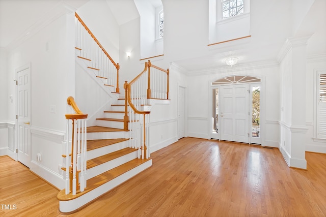 entryway featuring light hardwood / wood-style floors and ornamental molding