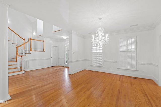 interior space featuring crown molding, light wood-type flooring, and a notable chandelier