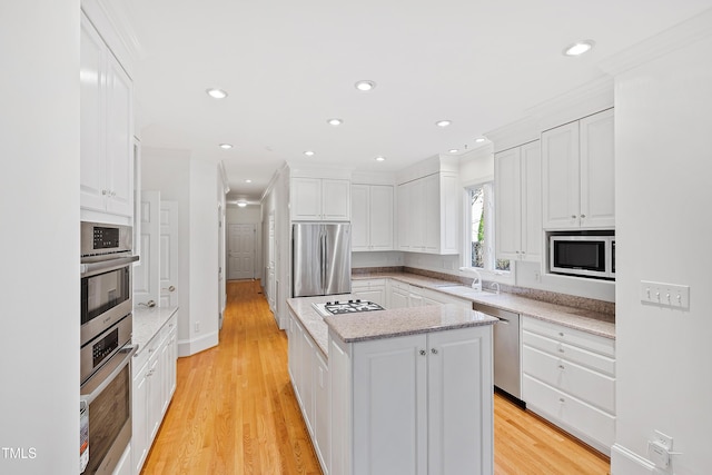 kitchen featuring white cabinetry, a kitchen island, and stainless steel appliances