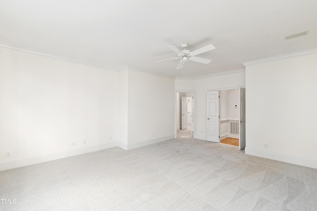 carpeted spare room with ceiling fan and ornamental molding