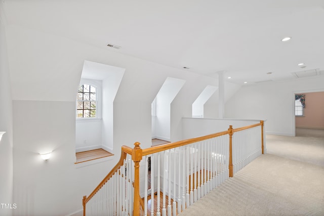 hallway with carpet floors and lofted ceiling