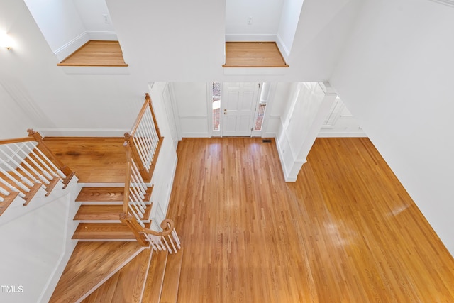 stairway with hardwood / wood-style floors