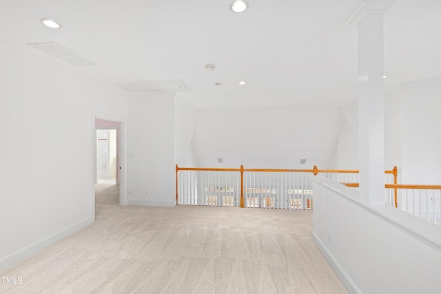 empty room with light colored carpet and crown molding