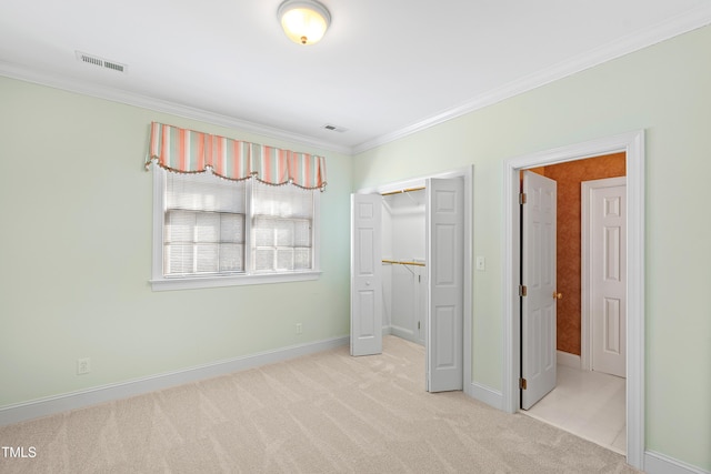 unfurnished bedroom with ornamental molding, light carpet, and a closet