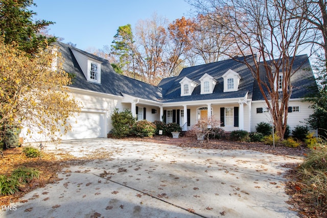 cape cod home with a porch and a garage