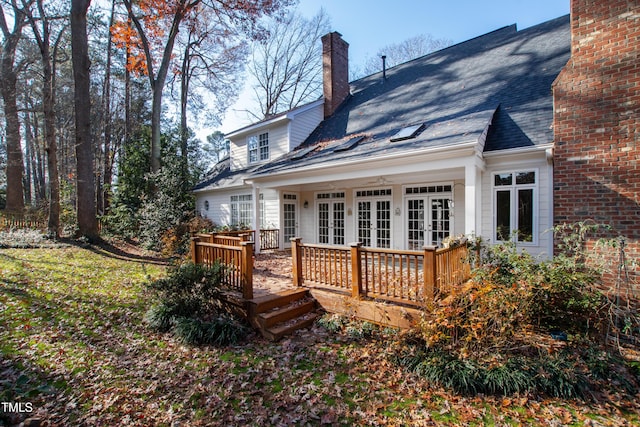 rear view of house with a deck and french doors