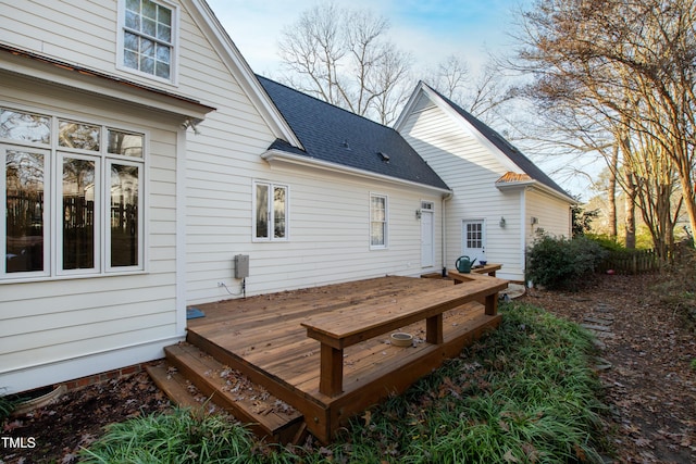 rear view of property featuring a wooden deck