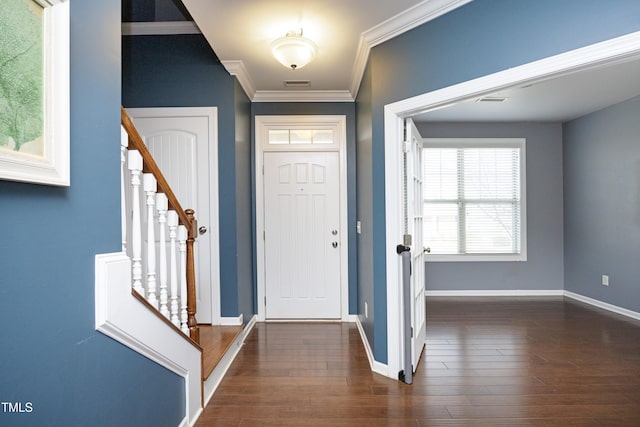 foyer entrance with crown molding and dark hardwood / wood-style floors