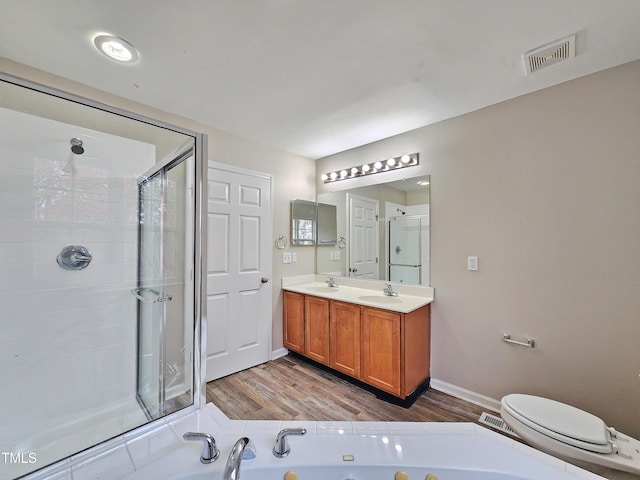 full bathroom featuring hardwood / wood-style flooring, vanity, toilet, and independent shower and bath