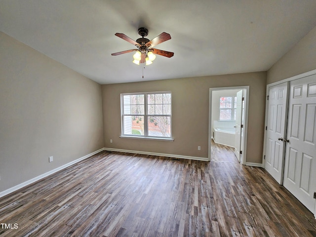 spare room featuring ceiling fan and dark wood-type flooring