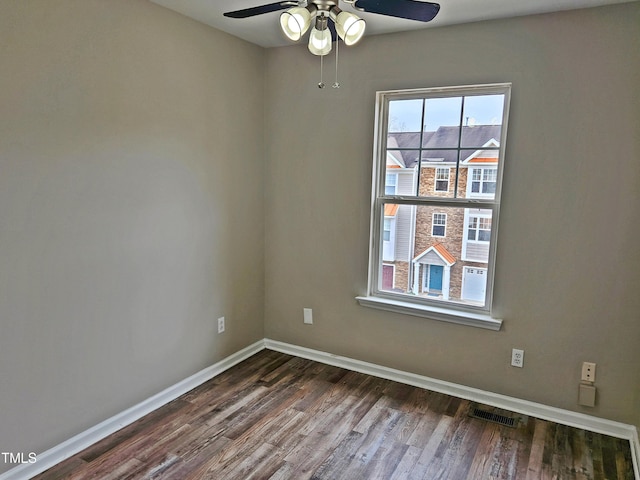 spare room with ceiling fan and dark hardwood / wood-style flooring