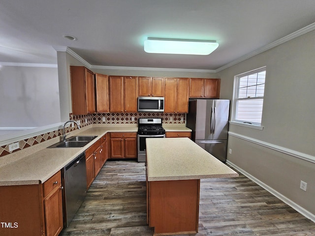 kitchen with sink, a center island, stainless steel appliances, and ornamental molding