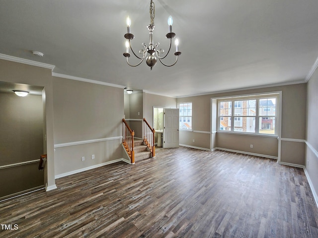 empty room featuring crown molding, a chandelier, and dark hardwood / wood-style floors