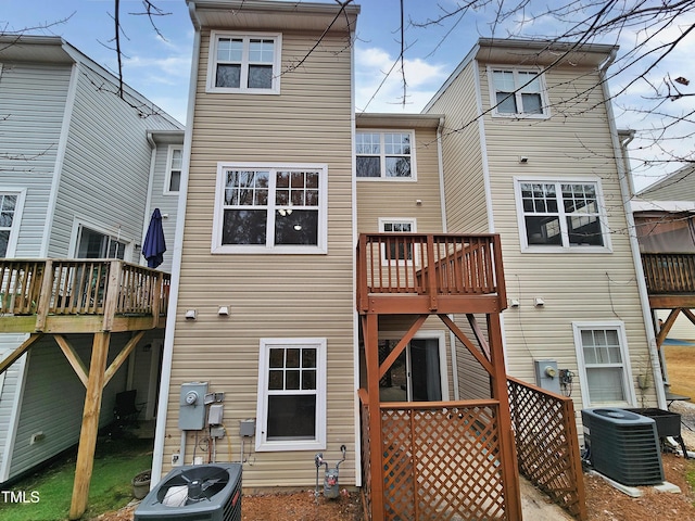 rear view of house with a wooden deck and central AC