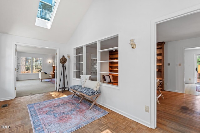 unfurnished room featuring baseboards, high vaulted ceiling, a skylight, and parquet flooring