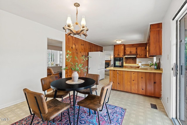 dining room featuring visible vents, baseboards, light floors, and a chandelier