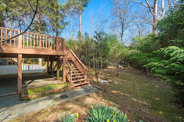 view of yard with stairway and a wooden deck