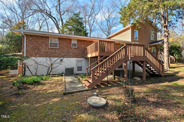 rear view of property with brick siding, central air condition unit, stairs, and a deck