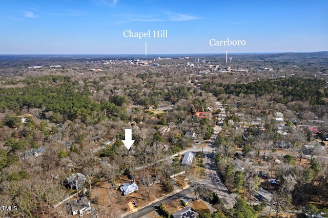 birds eye view of property featuring a view of trees