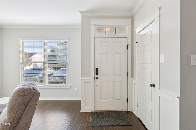 foyer with dark hardwood / wood-style floors and crown molding