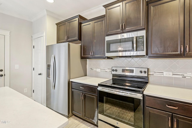 kitchen with stainless steel appliances, dark brown cabinets, backsplash, and ornamental molding