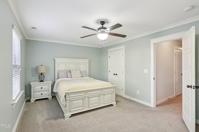 carpeted bedroom featuring ceiling fan, ornamental molding, and a closet