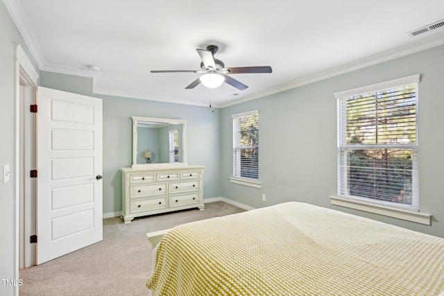 bedroom with ceiling fan, multiple windows, and crown molding