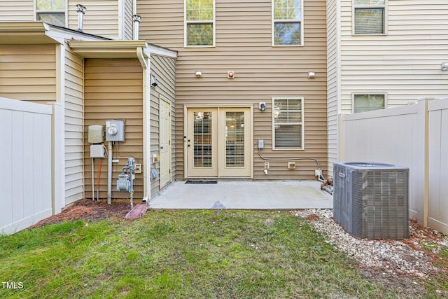 exterior space featuring central AC, a lawn, and a patio