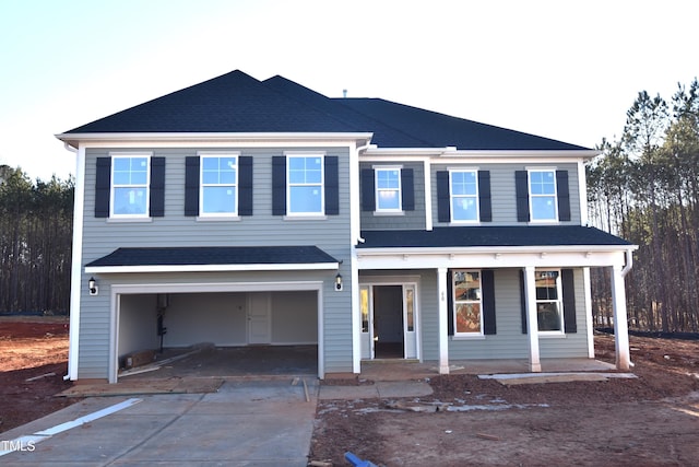 view of front facade with a porch and a garage