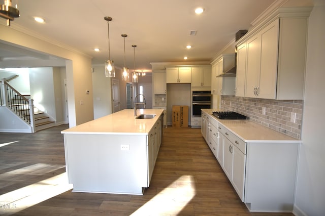 kitchen with dark wood-type flooring, stainless steel double oven, a sink, and backsplash