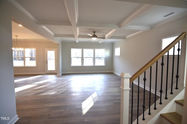 unfurnished living room featuring ceiling fan with notable chandelier, plenty of natural light, coffered ceiling, and visible vents