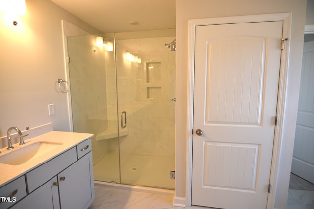 full bath featuring marble finish floor, a shower stall, and vanity