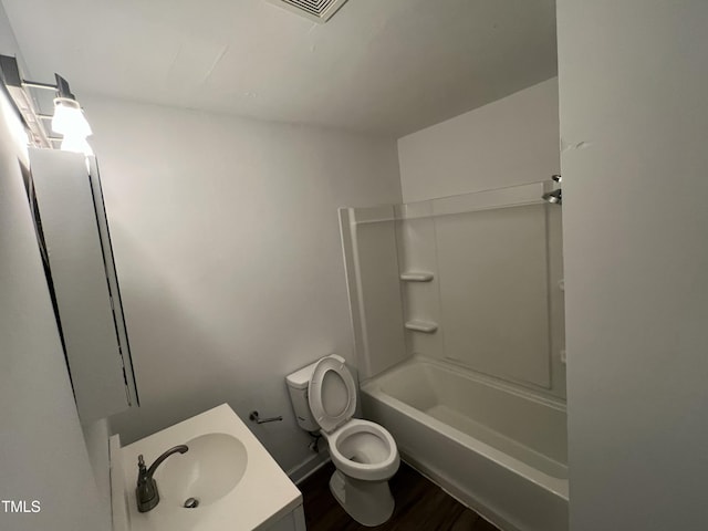 full bathroom featuring vanity, hardwood / wood-style flooring, shower / bathing tub combination, and toilet