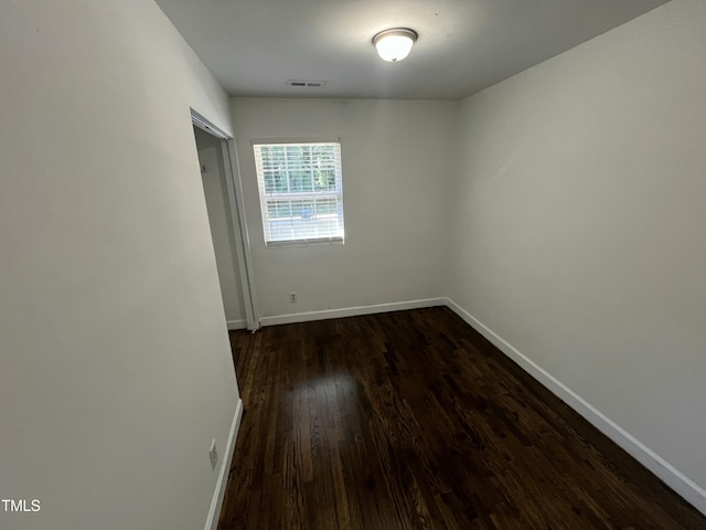 spare room with dark hardwood / wood-style flooring