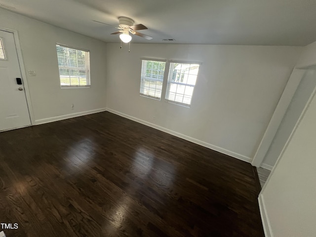 empty room featuring dark hardwood / wood-style flooring and ceiling fan