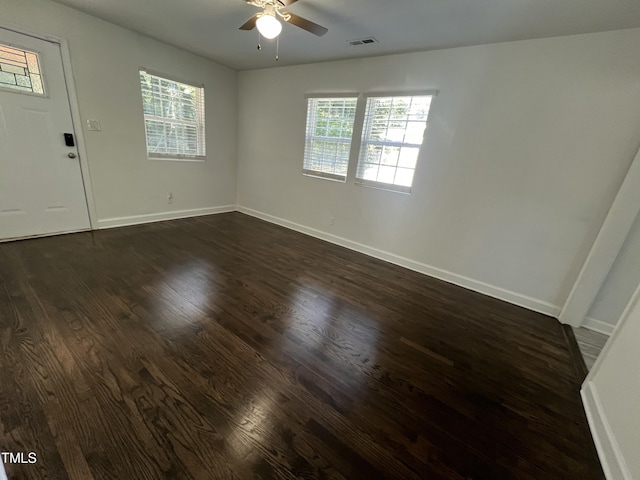 spare room with ceiling fan and dark wood-type flooring