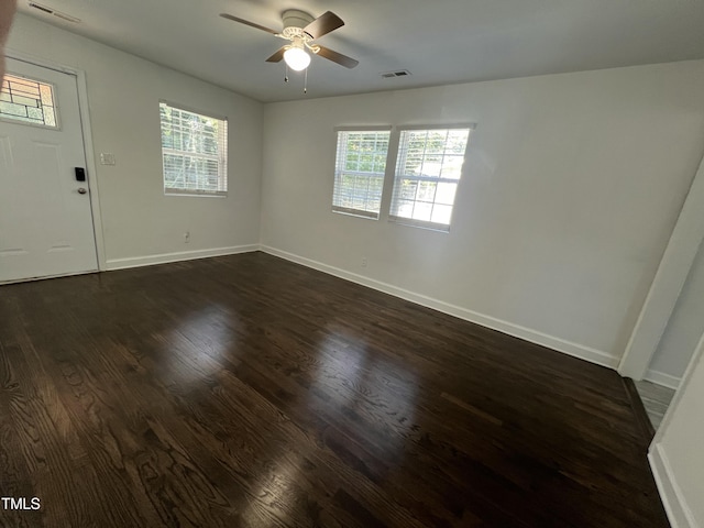 spare room with ceiling fan and dark hardwood / wood-style flooring