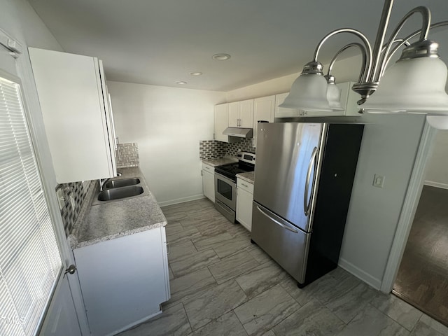 kitchen featuring white cabinets, decorative backsplash, stainless steel appliances, and sink