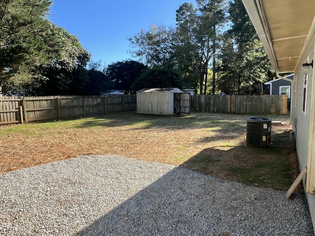 view of yard with central AC and a storage unit