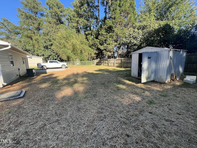 view of yard with central AC unit and a storage shed