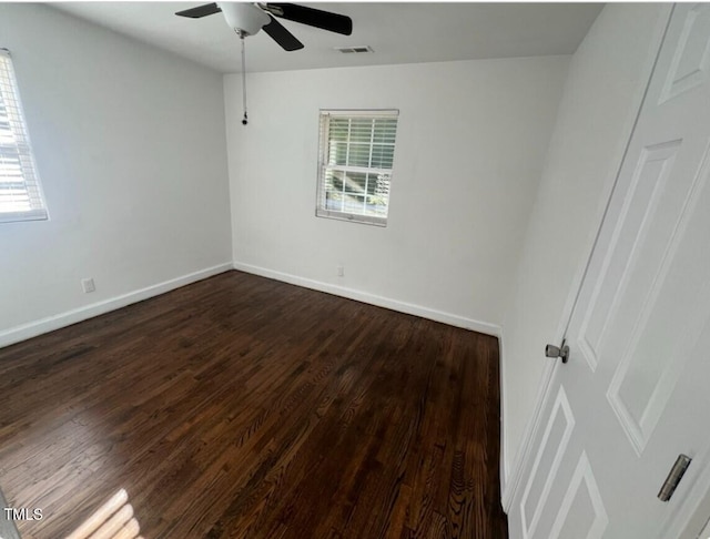 unfurnished room with dark hardwood / wood-style flooring and ceiling fan