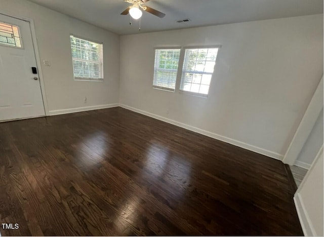 unfurnished room with ceiling fan and dark wood-type flooring